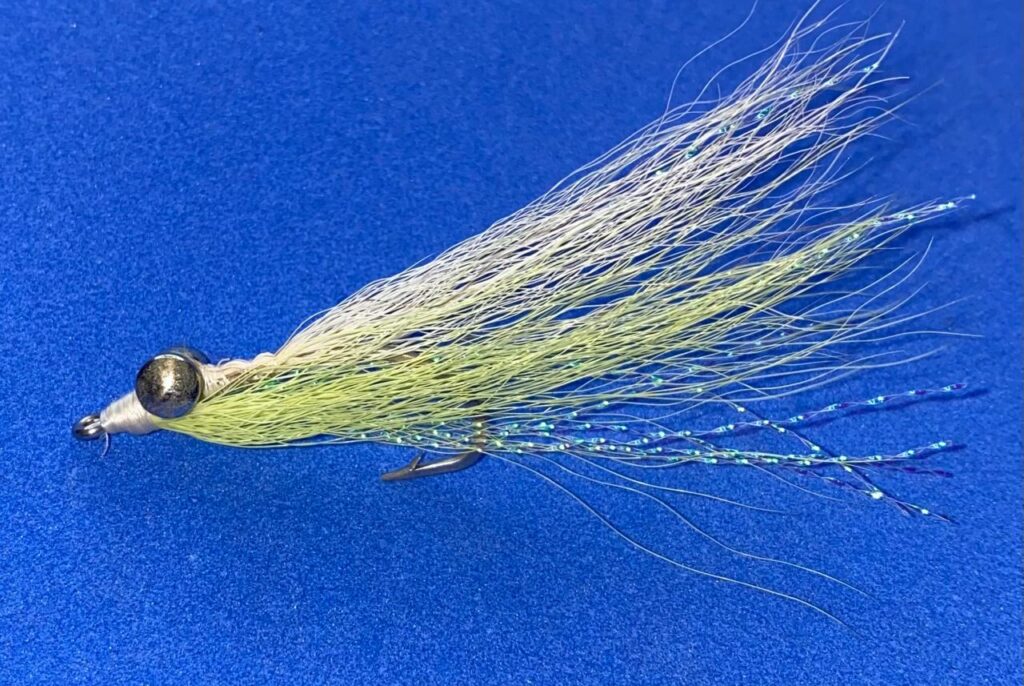 Clouser Minnow fly in white and chartreuse with dumbbell eyes secured at the front of the hook