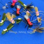 Hand-tied foam terrestrial flies including Chernobyl Ant, Chubby Chernobyl and Form Hopper patterns on a blue background